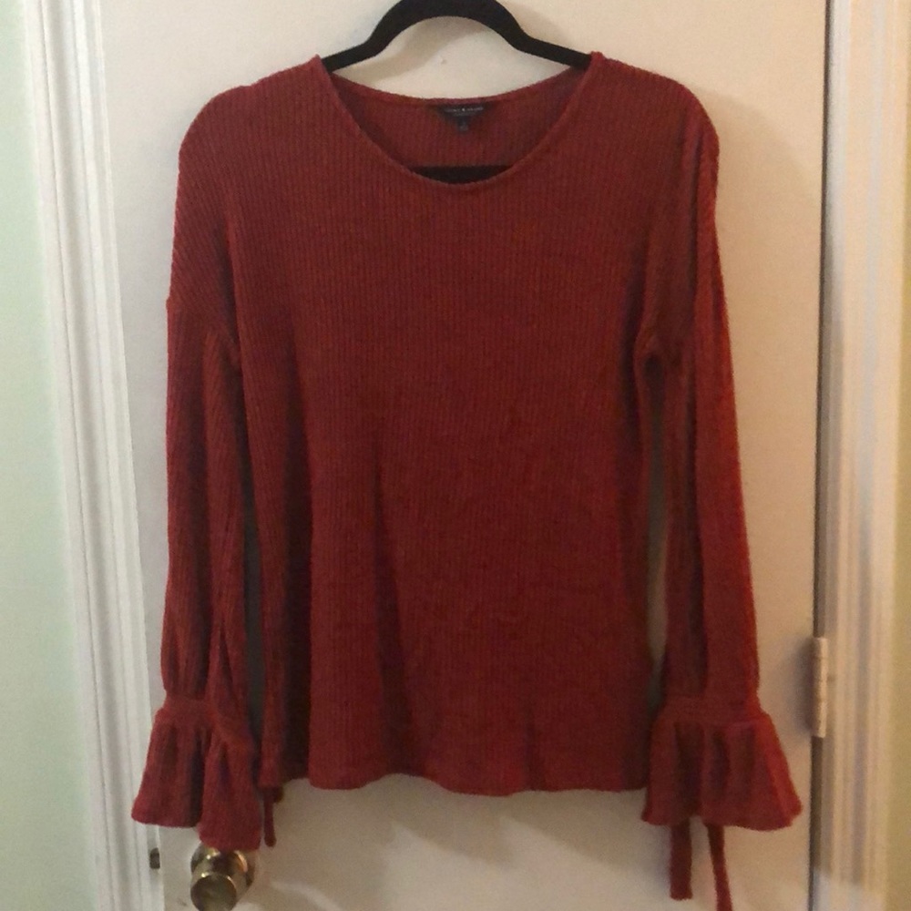 Small, orange Lucky Brand sweater.